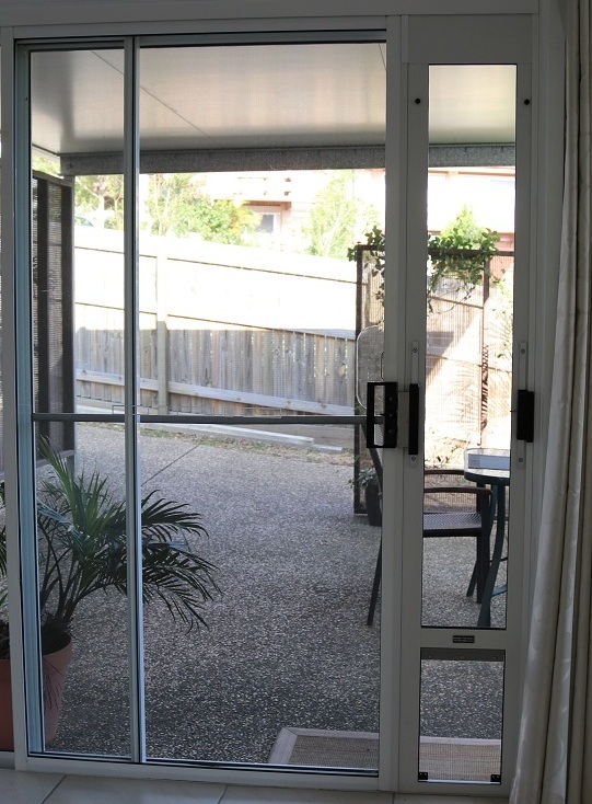 Main image: replace with your real PatioLock-installed dog photo